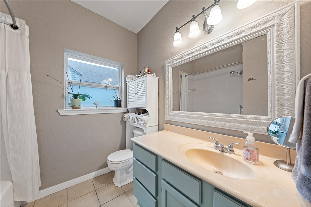 2923 Live Oak Avenue Waco, TX 76708 - Photo 15 of 22 a bathroom with a sink a toilet and mirror