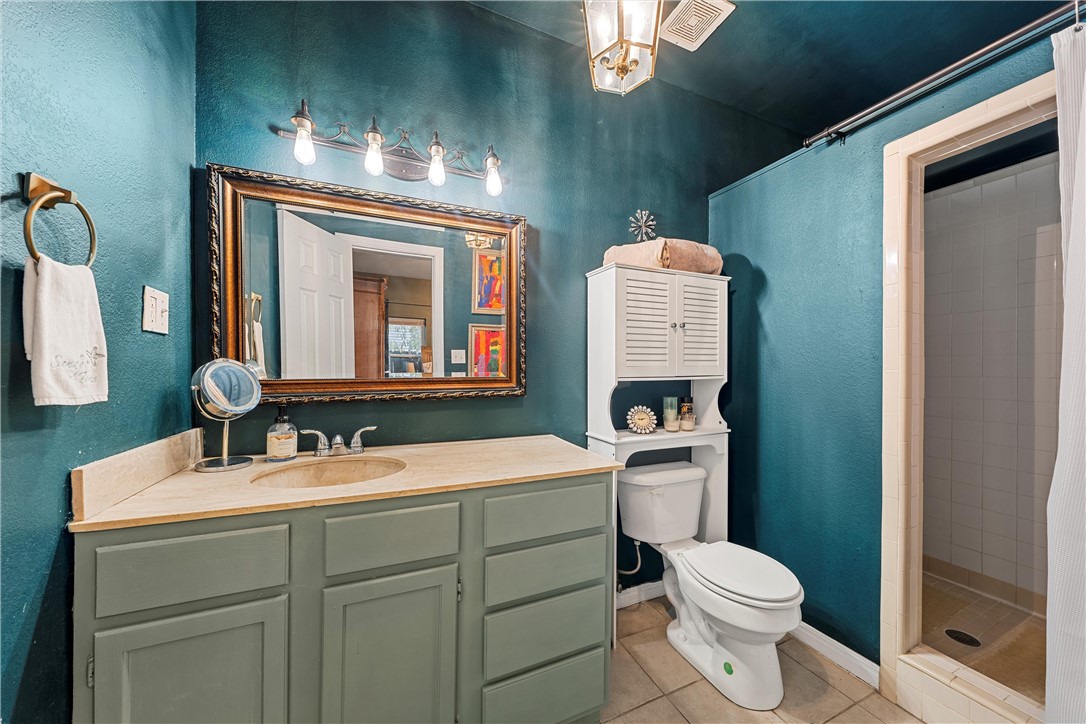 2923 Live Oak Avenue Waco, TX 76708 - Photo 17 of 22 a bathroom with a toilet sink and mirror