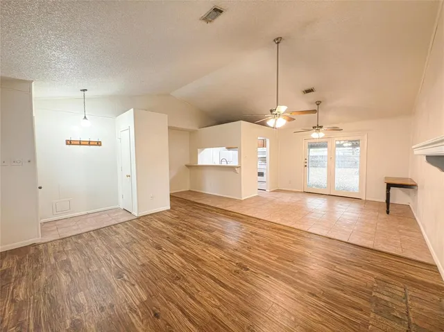 a view of a room with wooden floor and window