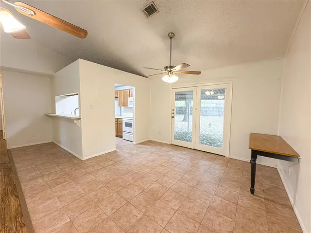 a view of a livingroom with a furniture and chandelier fan