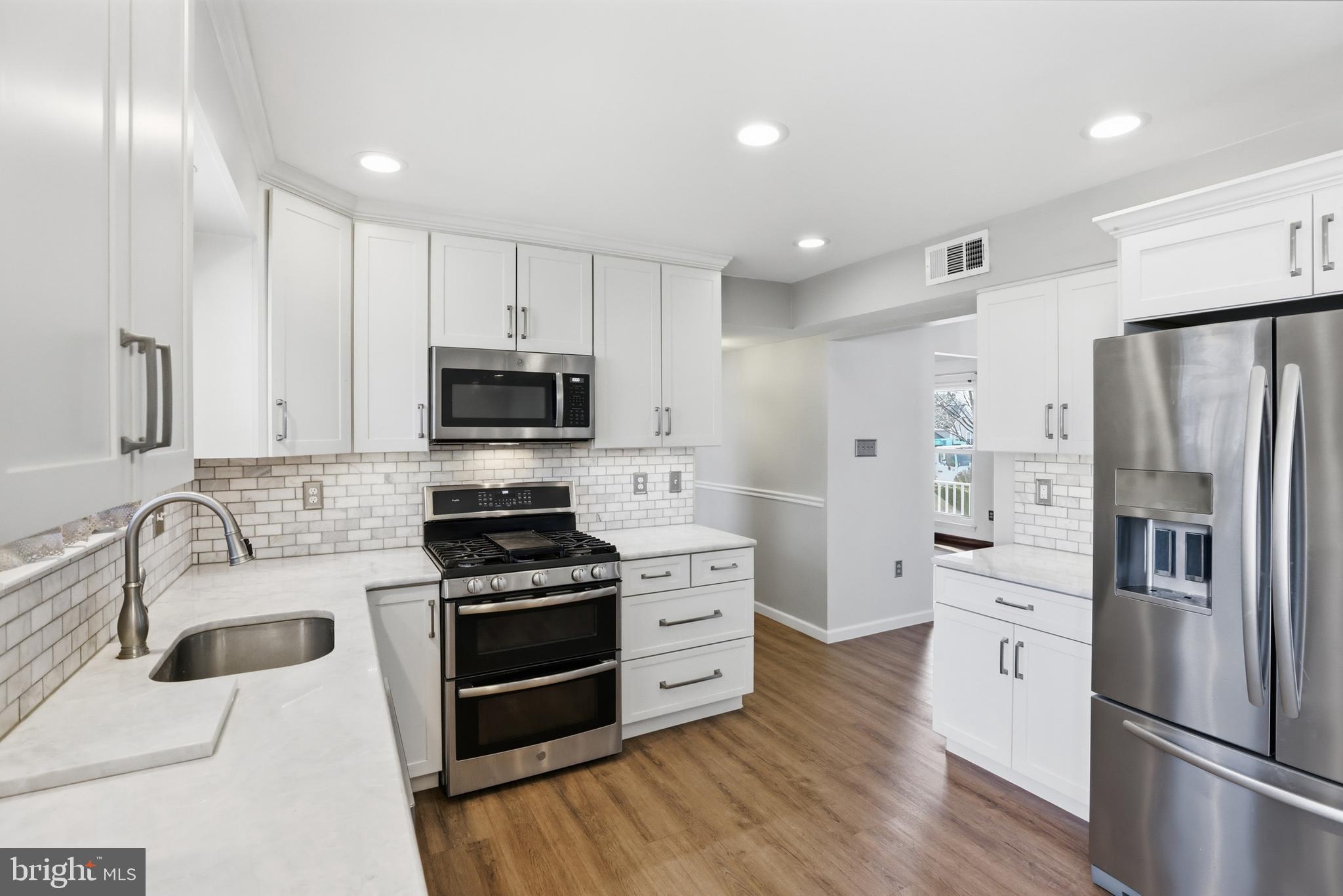 9709 Noble Ridge Terrace Gaithersburg, MD 20882 - Photo 16 of 64 a kitchen with stainless steel appliances a refrigerator stove and microwave