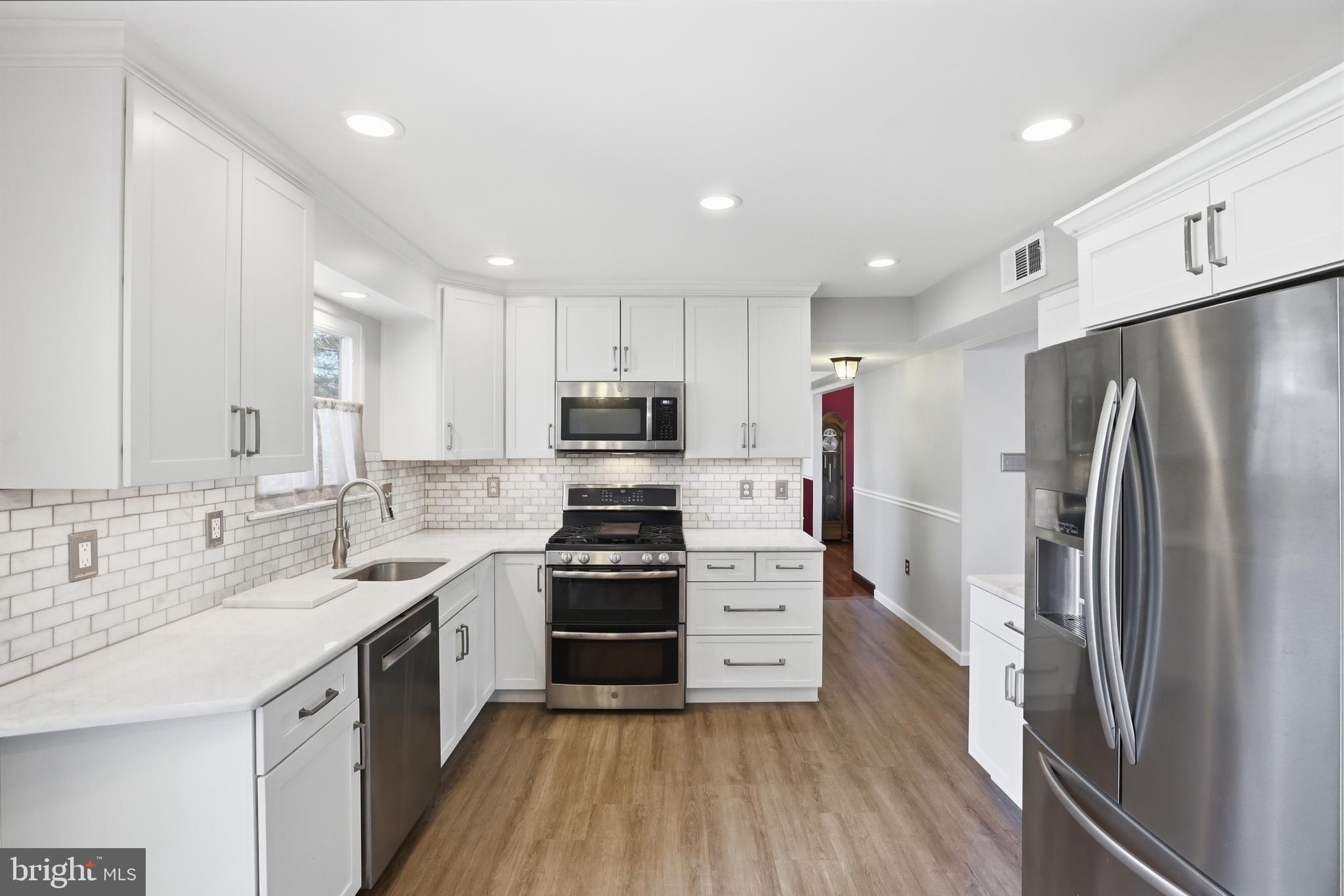 9709 Noble Ridge Terrace Gaithersburg, MD 20882 - Photo 17 of 64 a kitchen with stainless steel appliances a refrigerator sink and stove