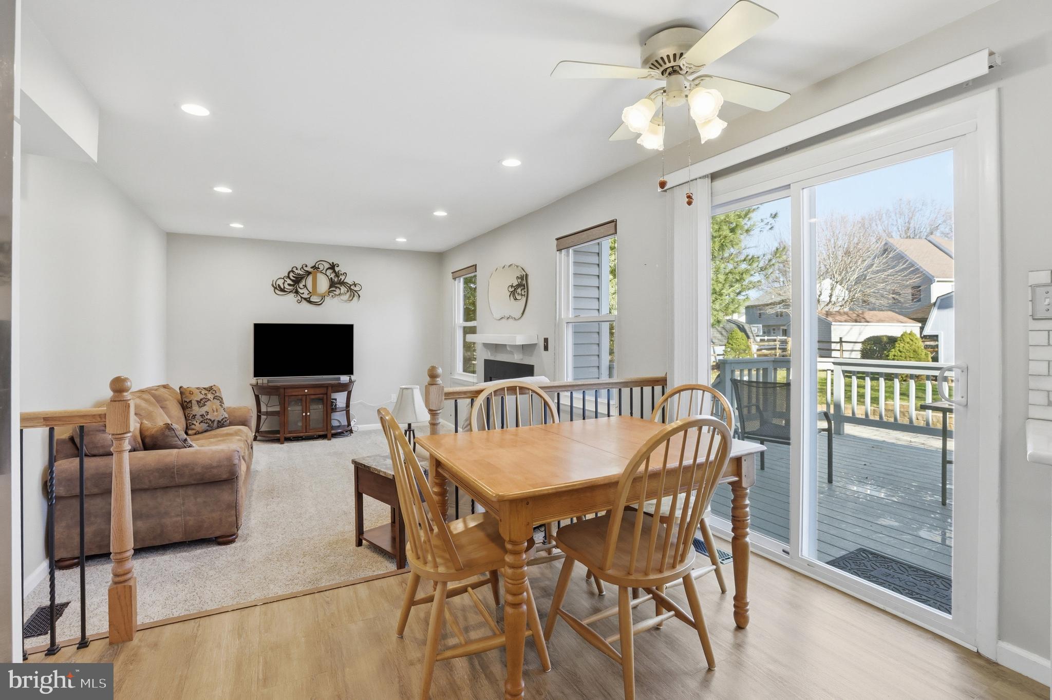 9709 Noble Ridge Terrace Gaithersburg, MD 20882 - Photo 18 of 64 a dining room with furniture a flat screen tv and a large window