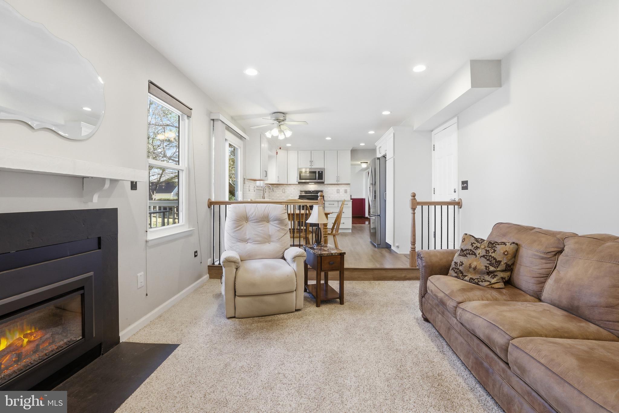 9709 Noble Ridge Terrace Gaithersburg, MD 20882 - Photo 19 of 64 a living room with furniture and a fireplace