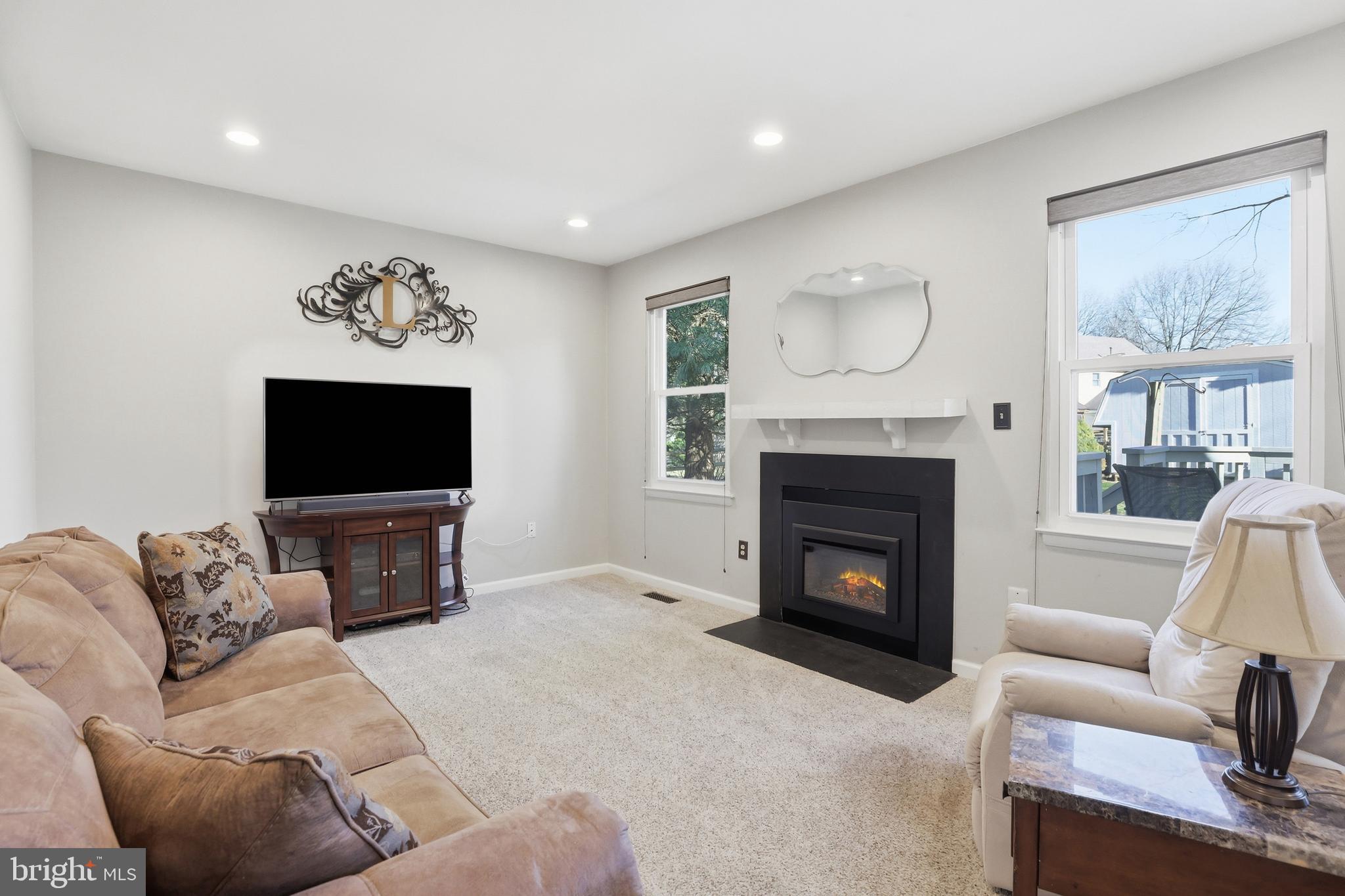 9709 Noble Ridge Terrace Gaithersburg, MD 20882 - Photo 20 of 64 a living room with furniture and a fireplace