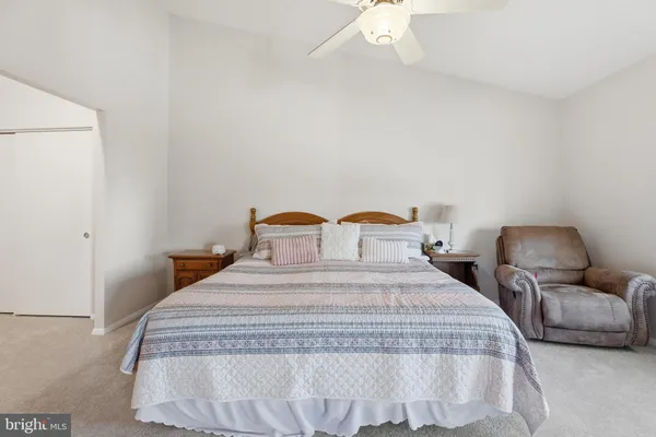 a spacious bedroom with a bed and cabinets
