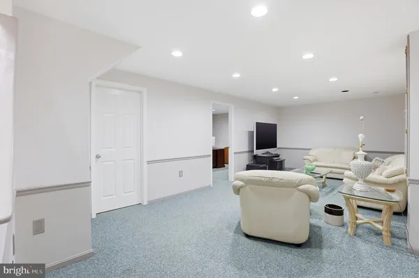 a view of a hallway with entryway and chandelier
