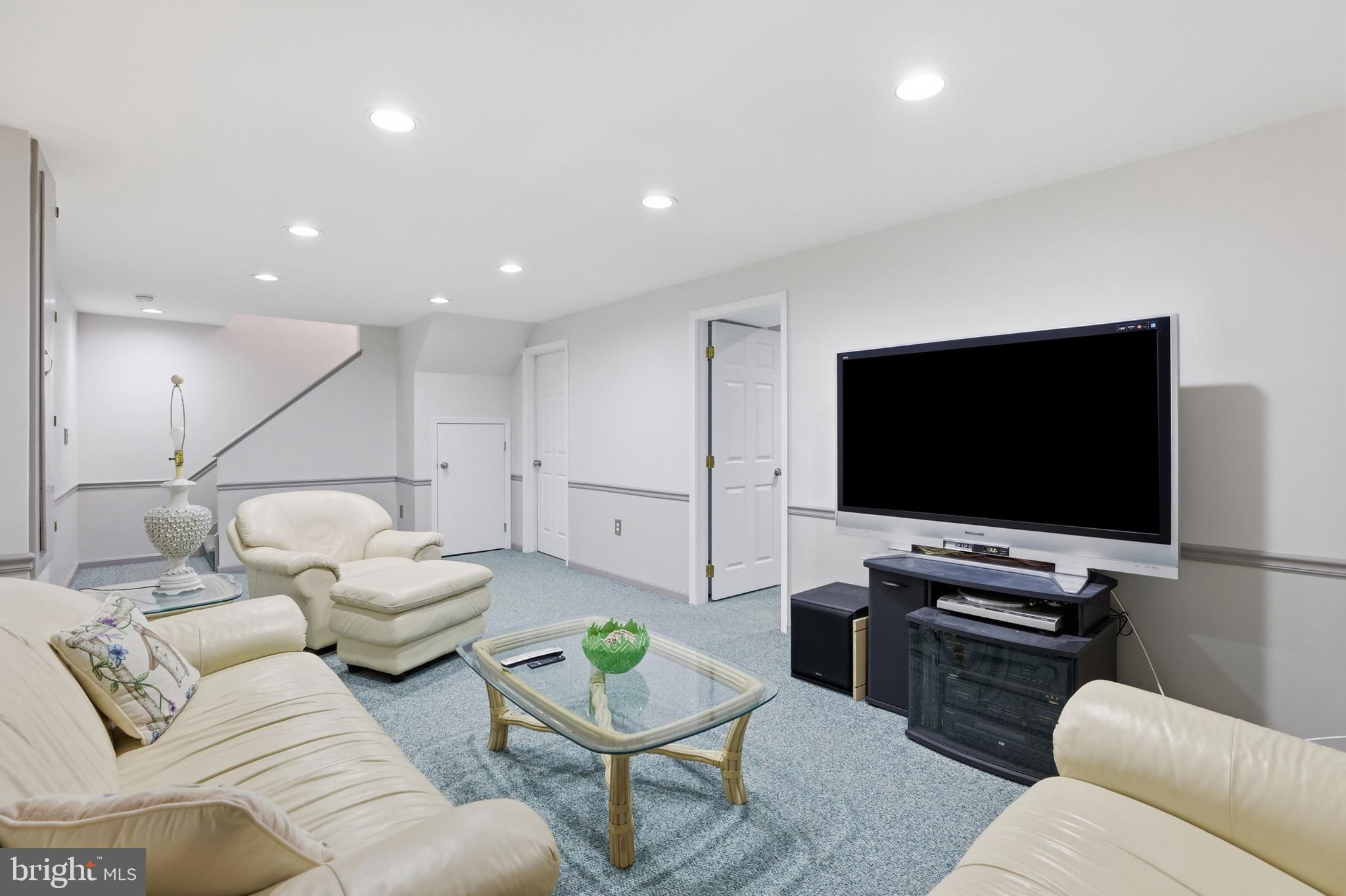 9709 Noble Ridge Terrace Gaithersburg, MD 20882 - Photo 38 of 64 a living room with furniture and a flat screen tv