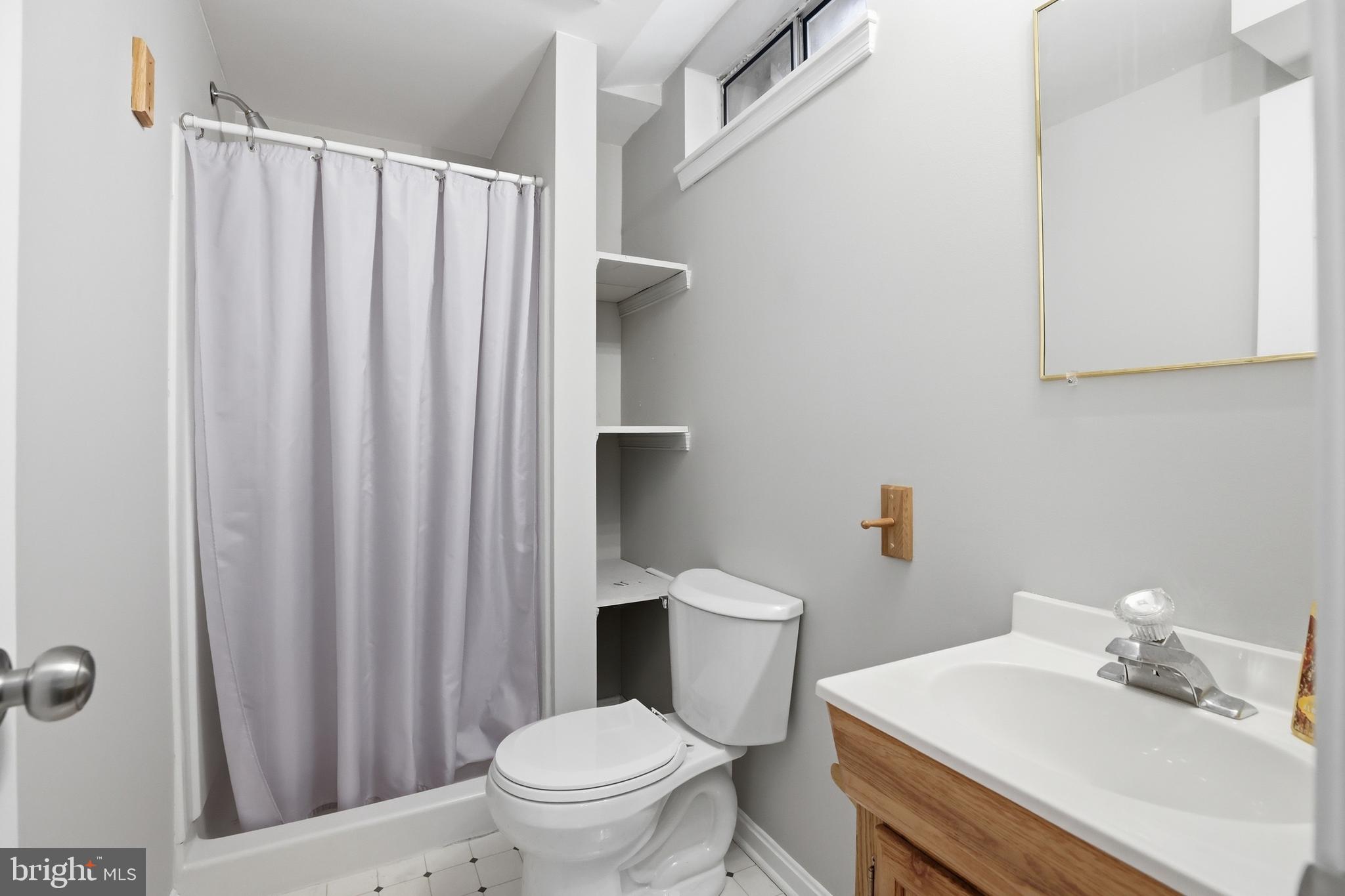9709 Noble Ridge Terrace Gaithersburg, MD 20882 - Photo 39 of 64 a bathroom with a sink a toilet and shower curtain