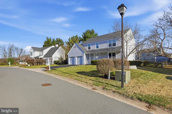 a front view of a house with a garden and yard