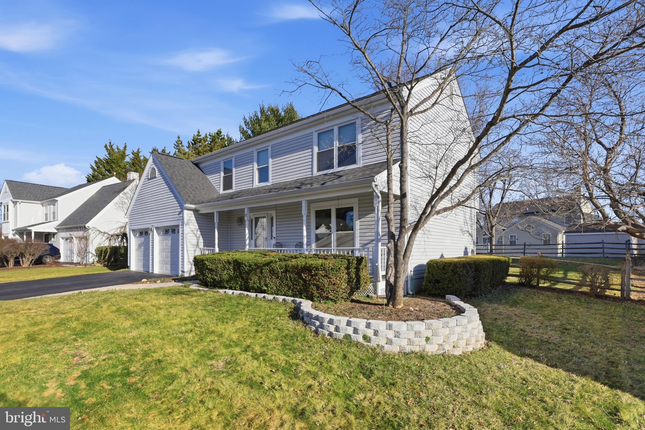9709 Noble Ridge Terrace Gaithersburg, MD 20882 - Photo 5 of 64 a front view of a house with a yard