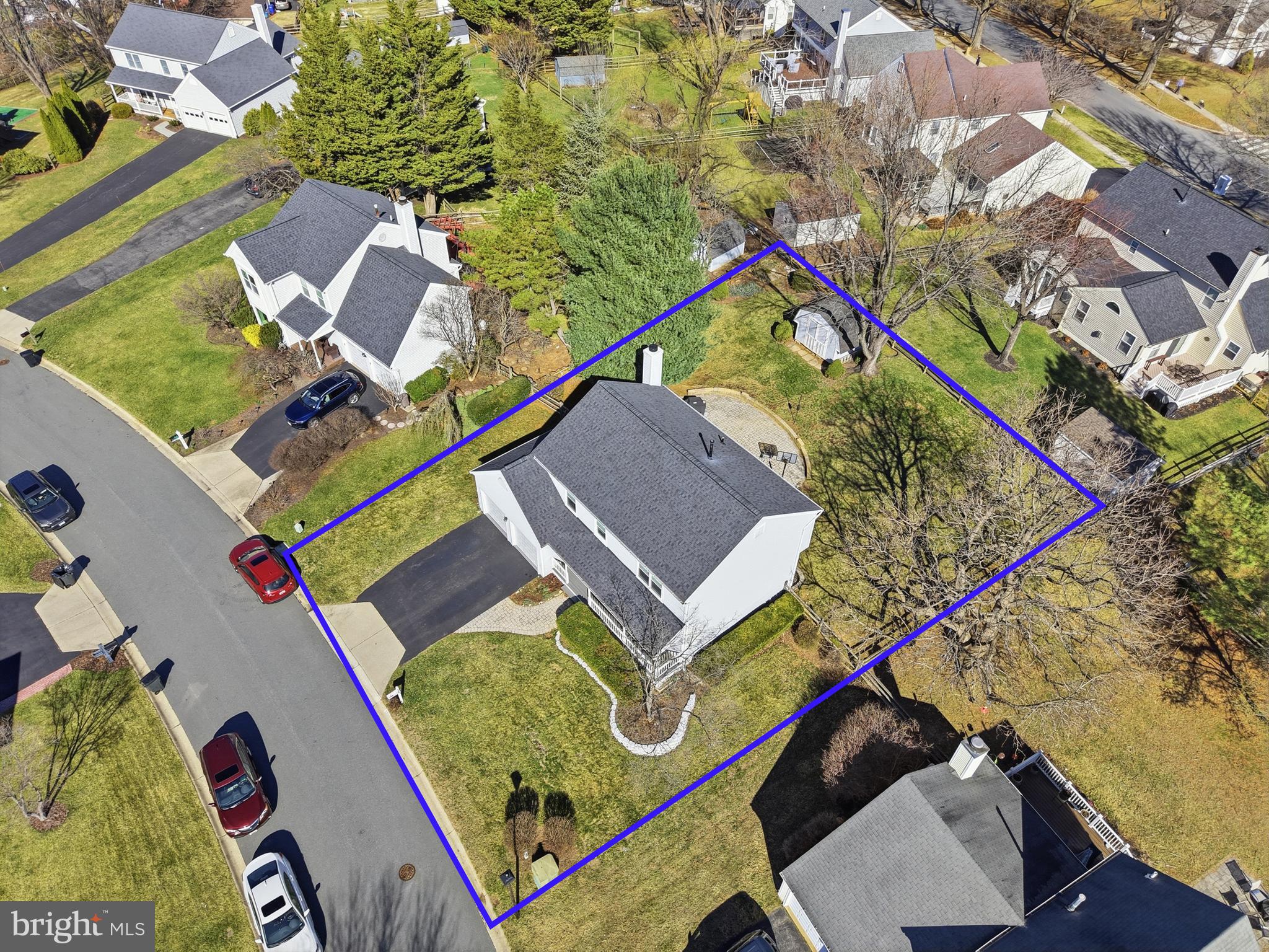 9709 Noble Ridge Terrace Gaithersburg, MD 20882 - Photo 51 of 64 an aerial view of a tennis ground with a large tree