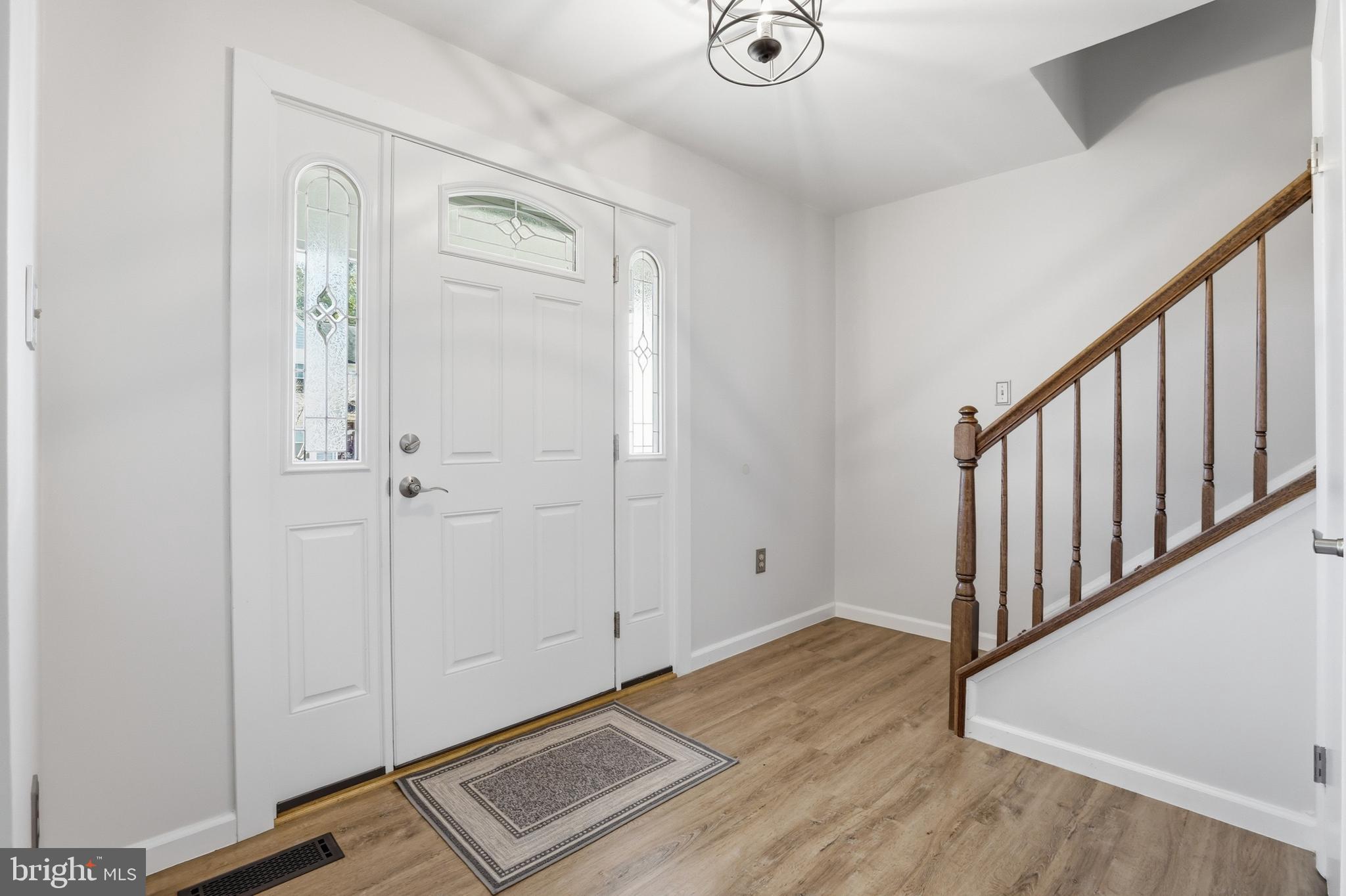 9709 Noble Ridge Terrace Gaithersburg, MD 20882 - Photo 8 of 64 a view of an entryway with wooden floor