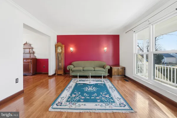a living room with furniture rug and wooden floor
