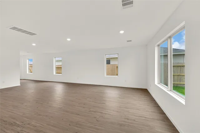 a view of a livingroom with wooden floor and window