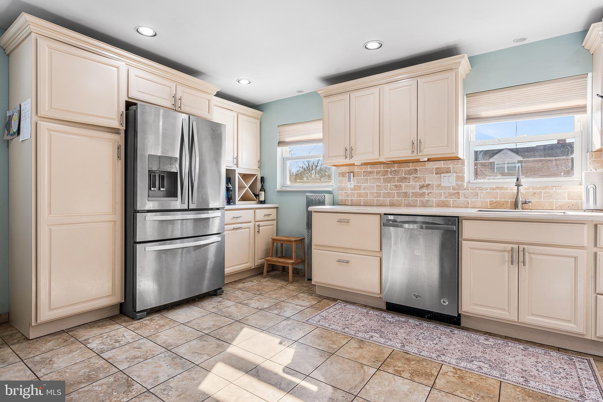 7381 Valley Avenue Philadelphia, PA 19128 - Photo 3 of 14 a kitchen with white cabinets stainless steel appliances and a window