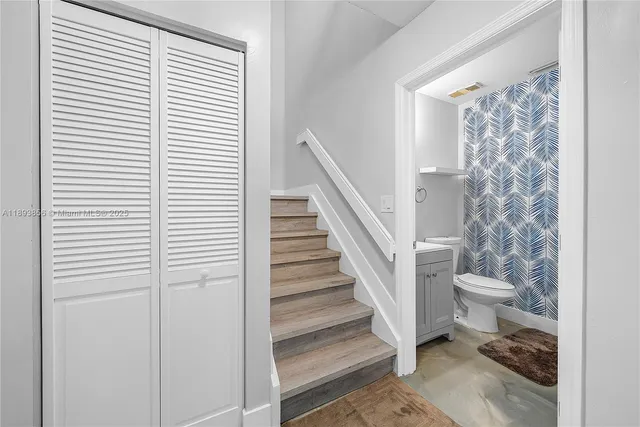 a bathroom with a toilet and a window