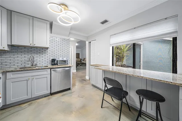 a kitchen with cabinets a sink and appliances