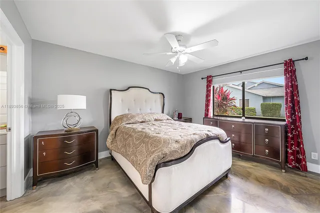 a bedroom with a large bed and a flat tv screen on dresser