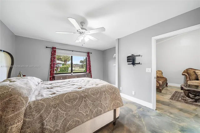 a bedroom with a bed and dresser with mirror