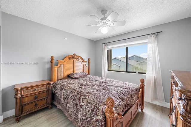 a bedroom with a bed and a painting on the wall