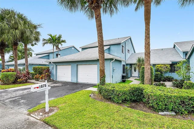 a front view of house with yard and green space