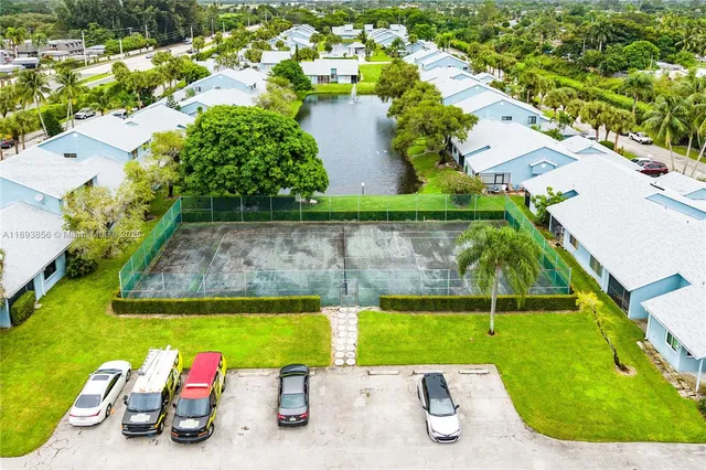 an aerial view of a swimming pool with a yard