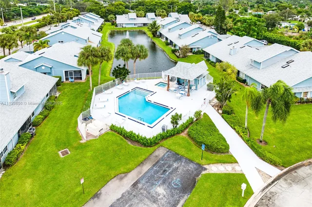 an aerial view of residential houses with outdoor space