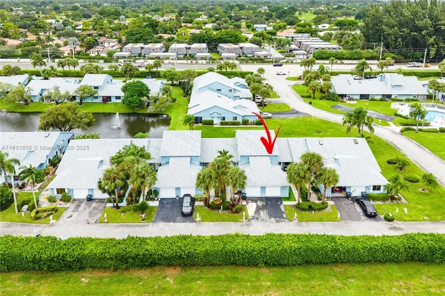 an aerial view of residential houses with outdoor space and swimming pool