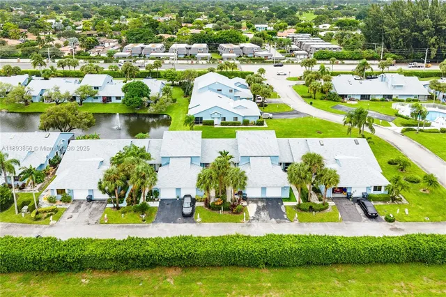 an aerial view of residential houses with outdoor space and swimming pool