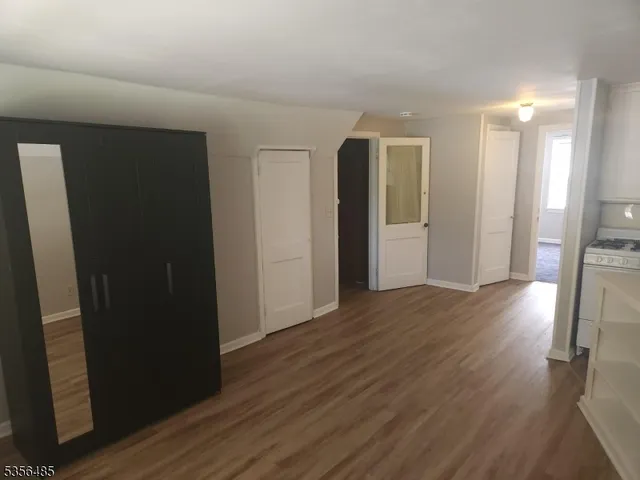 a view of hallway with wooden floor