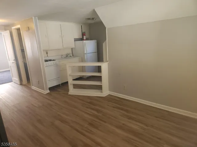 a view of a refrigerator in kitchen and wooden floor