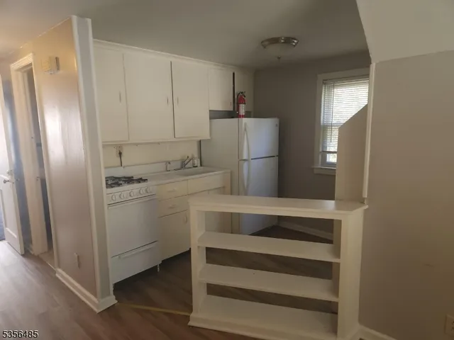 a utility room with cabinets washer and dryer