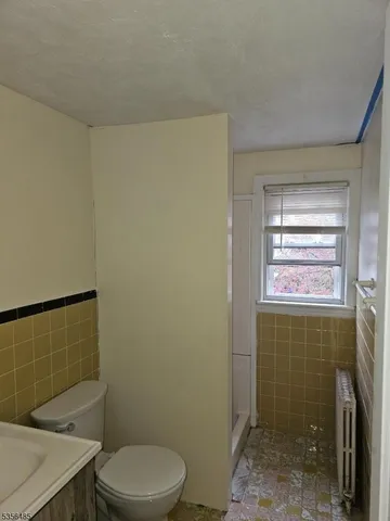 a bathroom with a toilet a sink and shower