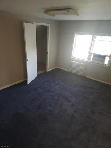 an empty room that has a window in it