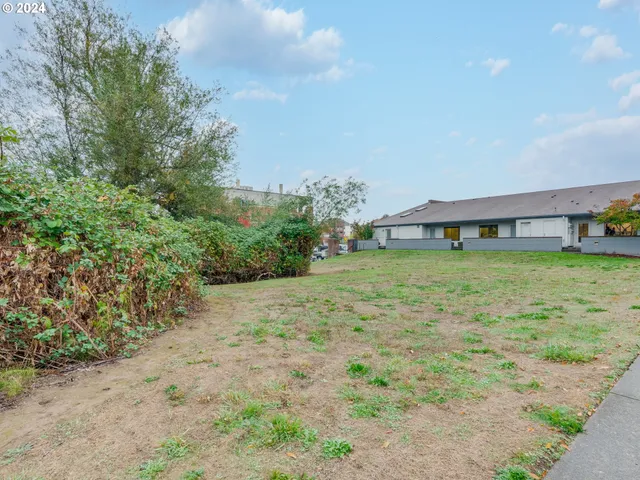 a view of a house with a yard and sitting area