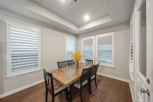 a view of a dining room with furniture and wooden floor