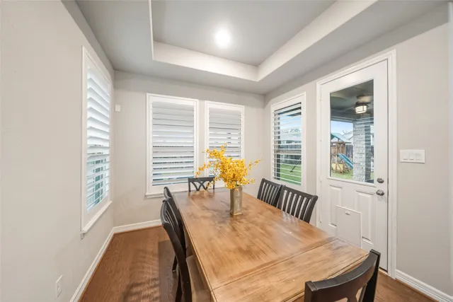 a dining room with furniture and wooden floor