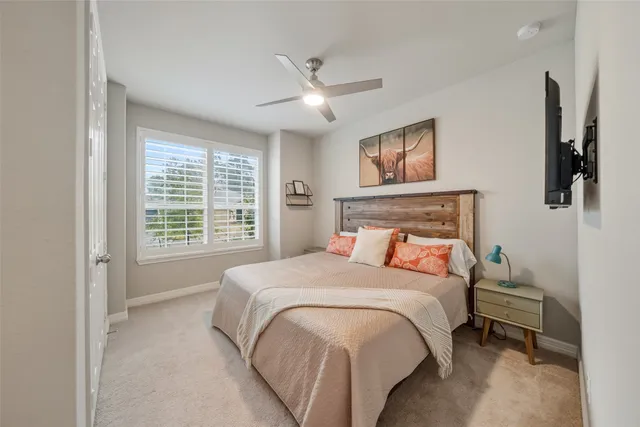 a bedroom with a large bed and a window