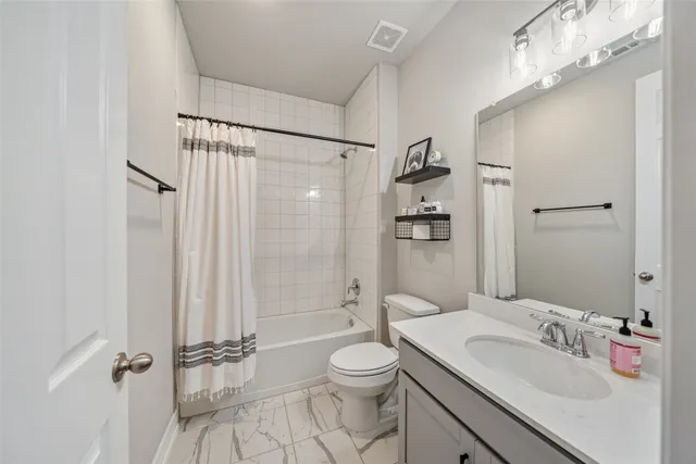 a bathroom with a sink toilet tub and shower