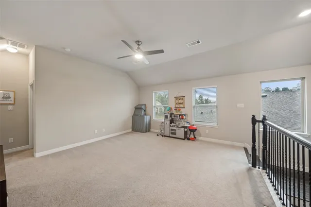 a view of a livingroom with furniture and a ceiling fan