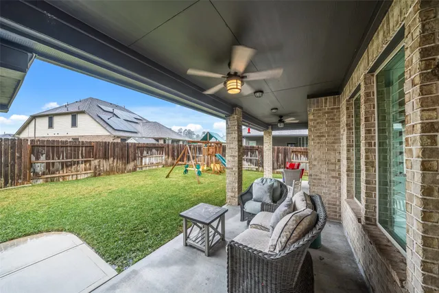 a view of a porch with furniture and garden