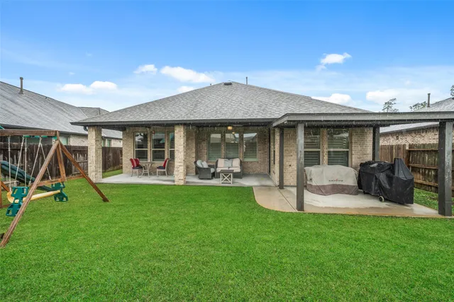 a view of a house with backyard porch and sitting area