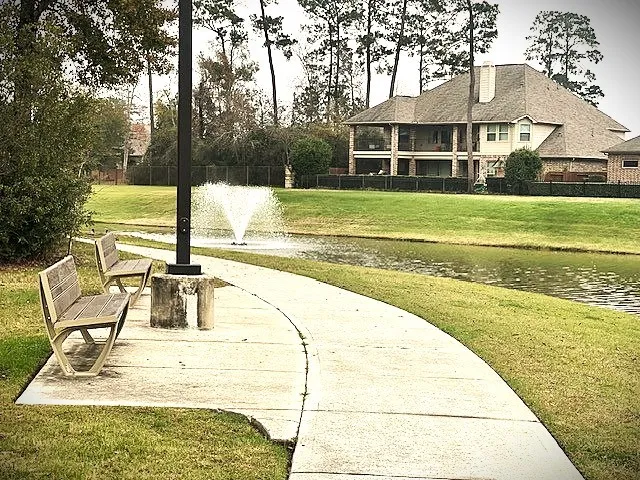 a backyard of a house with lots of green space and lake view