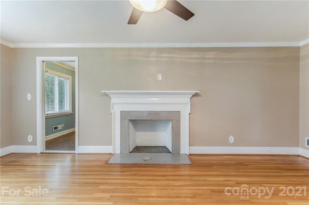 306 Kimmswick Road Charlotte, NC 28214 - Photo 11 of 21 a view of an empty room with wooden floor and a window