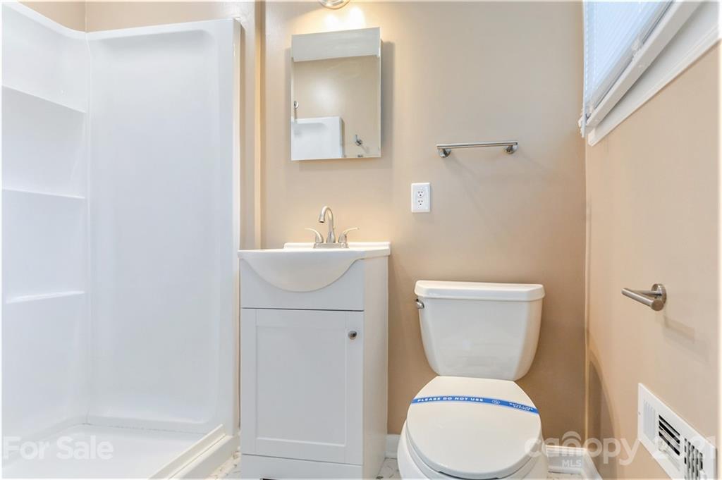306 Kimmswick Road Charlotte, NC 28214 - Photo 15 of 21 a white toilet sitting next to a bathroom sink