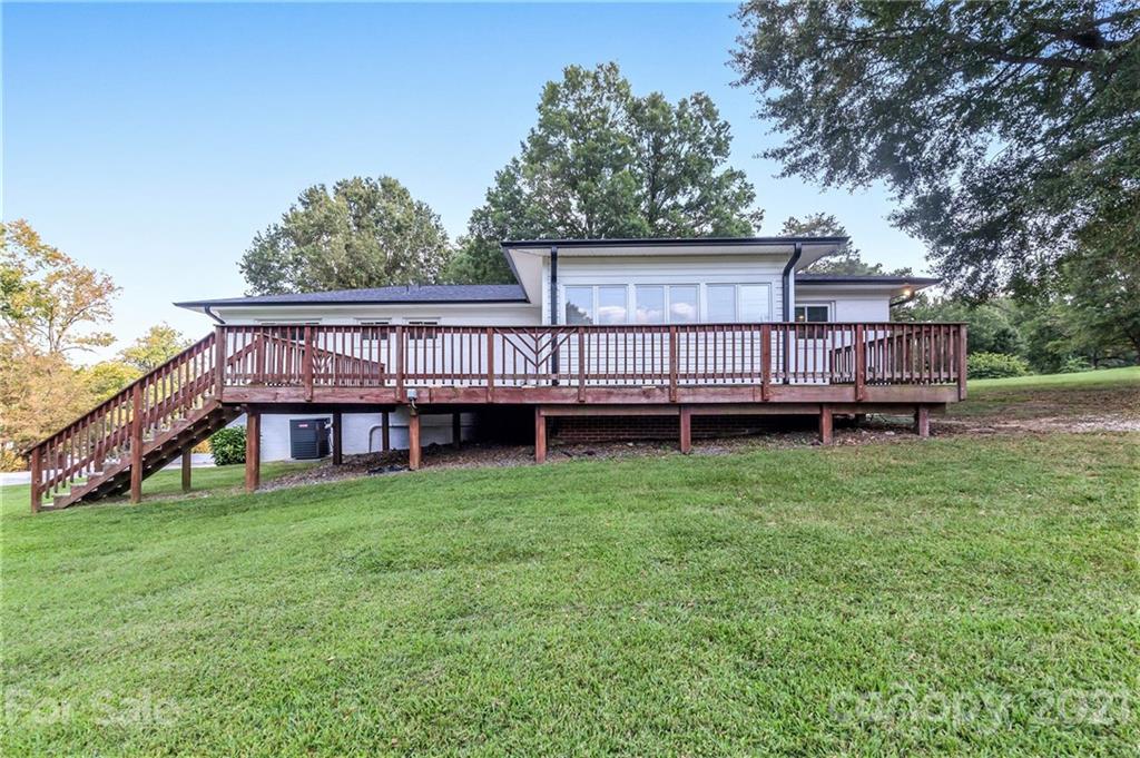 306 Kimmswick Road Charlotte, NC 28214 - Photo 16 of 21 a view of a house with a backyard and a deck