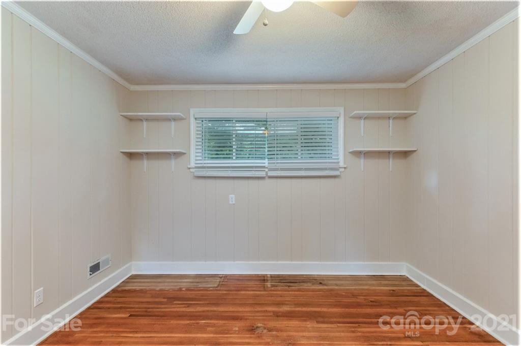 306 Kimmswick Road Charlotte, NC 28214 - Photo 20 of 21 a view of an empty room with wooden floor and a window