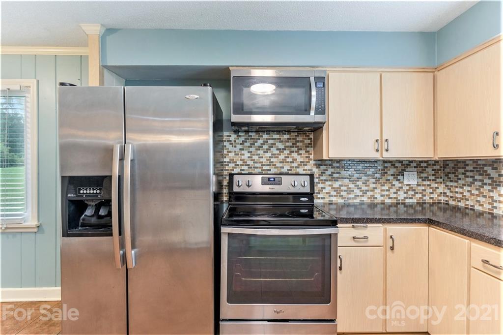 306 Kimmswick Road Charlotte, NC 28214 - Photo 5 of 21 a kitchen with a refrigerator and a stove top oven