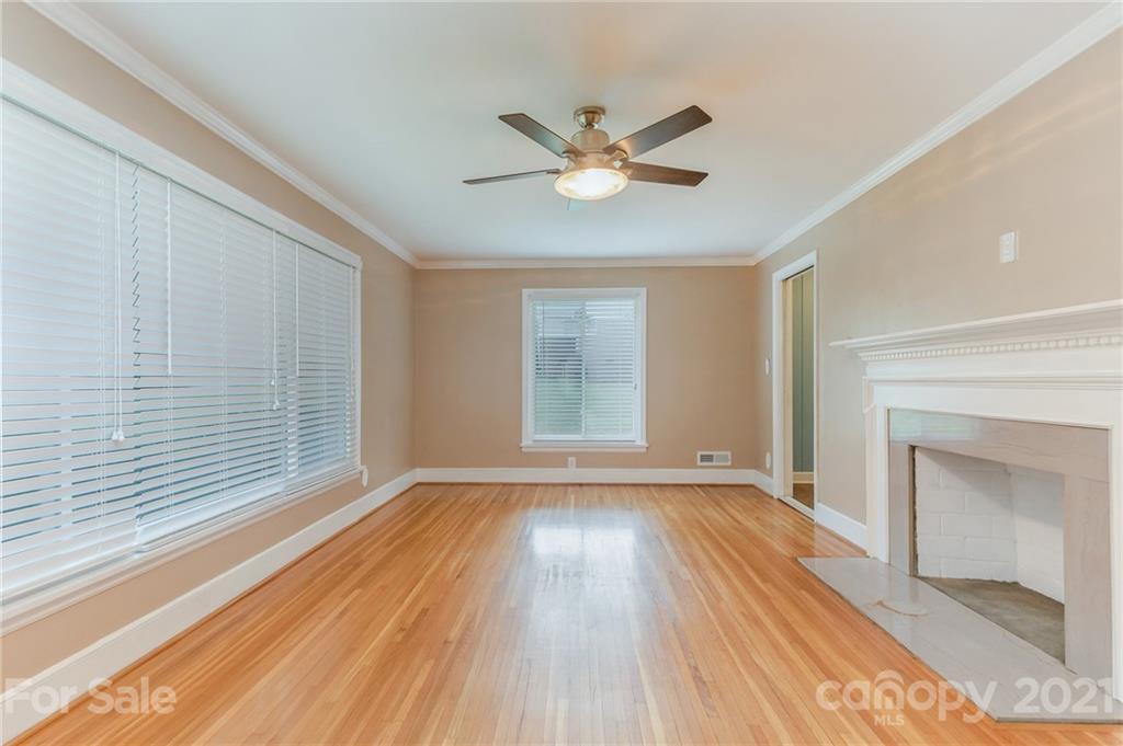 306 Kimmswick Road Charlotte, NC 28214 - Photo 10 of 21 a view of an empty room with wooden floor and a window
